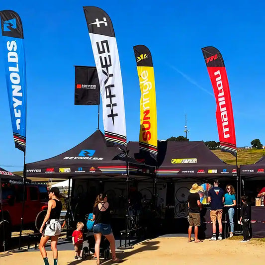 Pyrasun professional custom canopy tent with multiple feather flags, outdoor event branding solutions for sponsor booths.